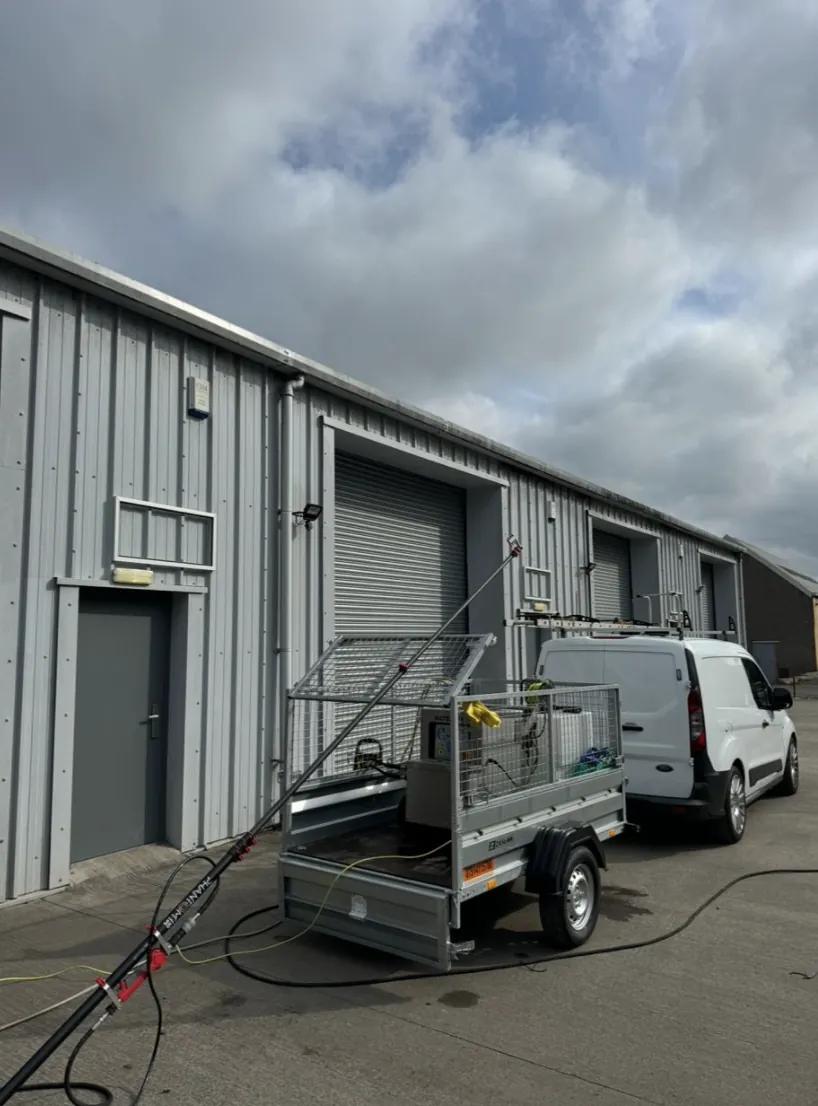 AD Roofing van and pressure-washing trailer ready for a property maintenance job