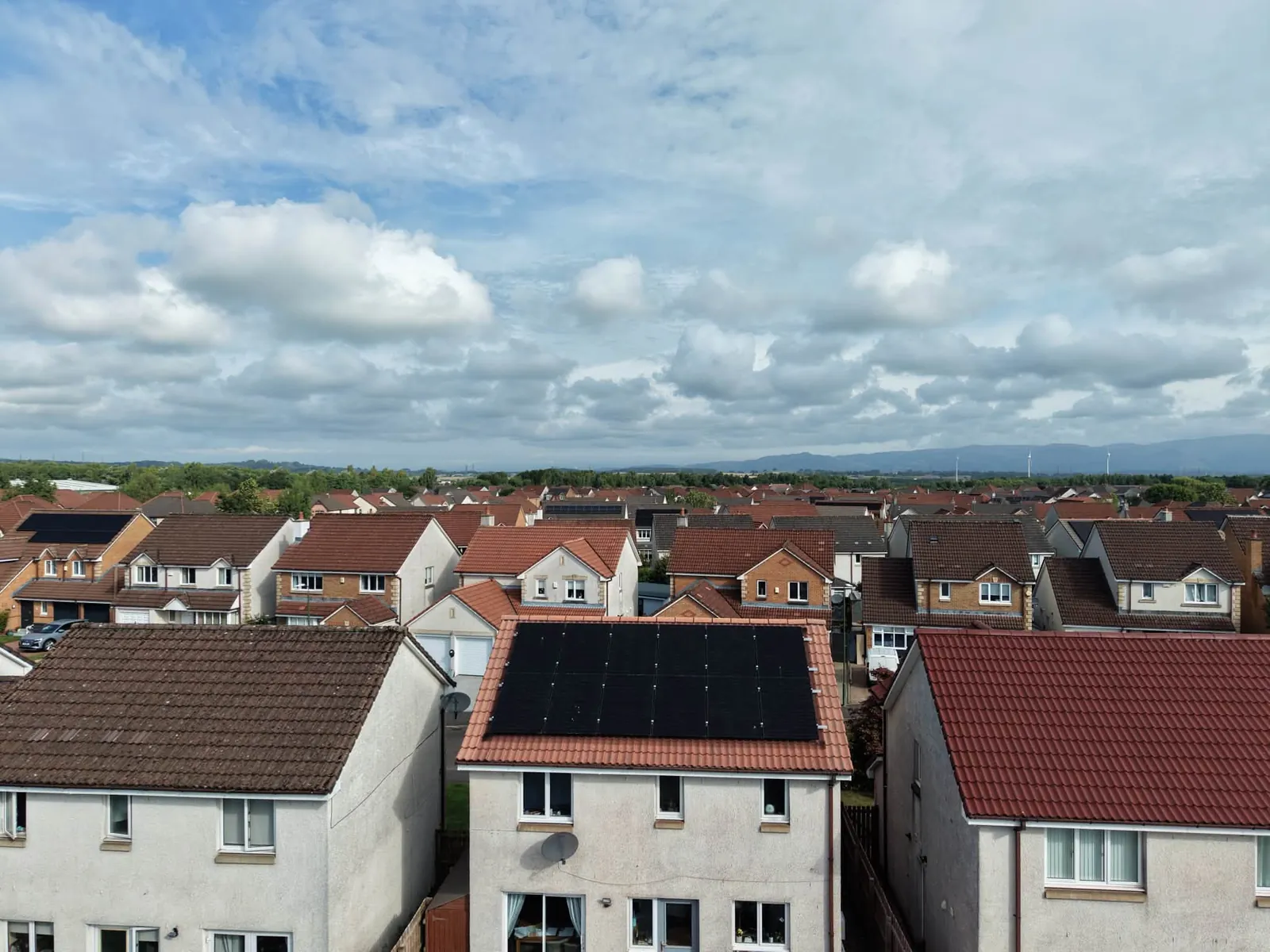 Aerial view over rooftops used to inspect roof condition