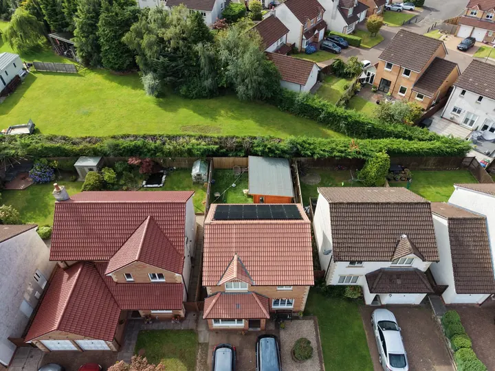Aerial view of a house and garden showing the full roof