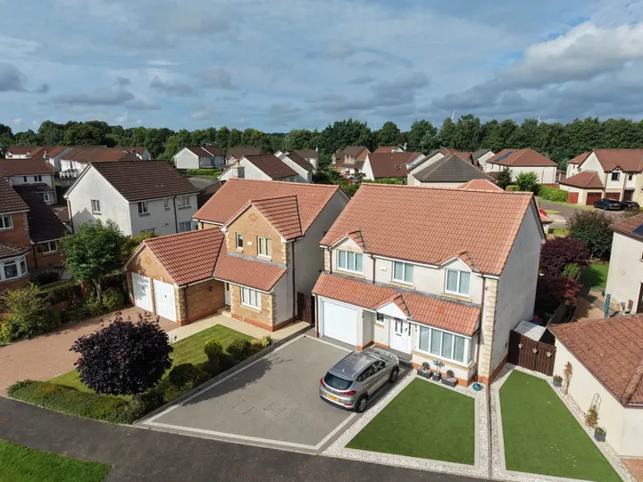 Detached home with a red tiled roof photographed by drone