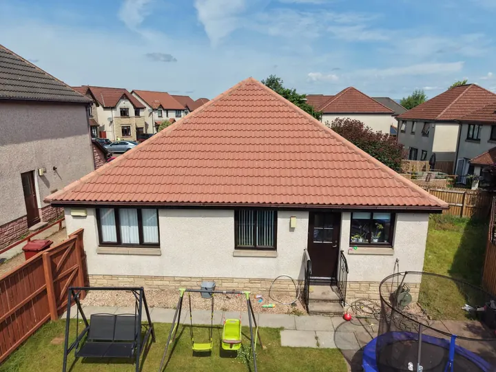 Bungalow with a clean red tiled roof