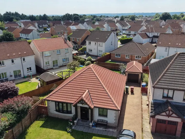 Bungalow with a pristine red tiled roof from above