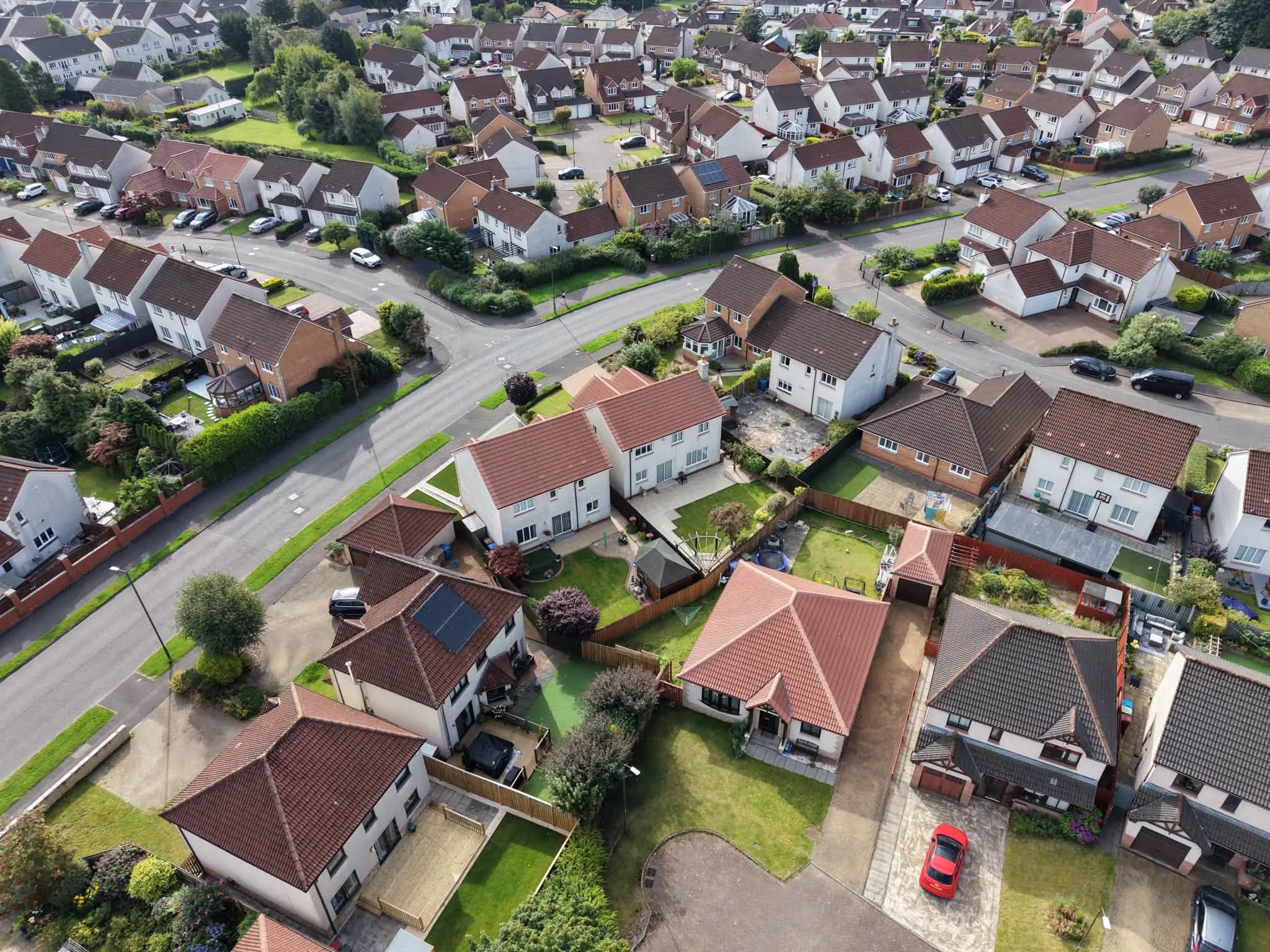 Aerial view of a housing estate of tiled roofs in the Falkirk area