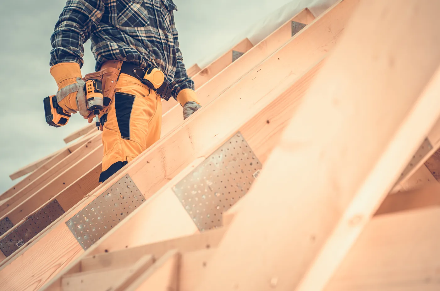 Roofer fixing the timber structure of a new roof